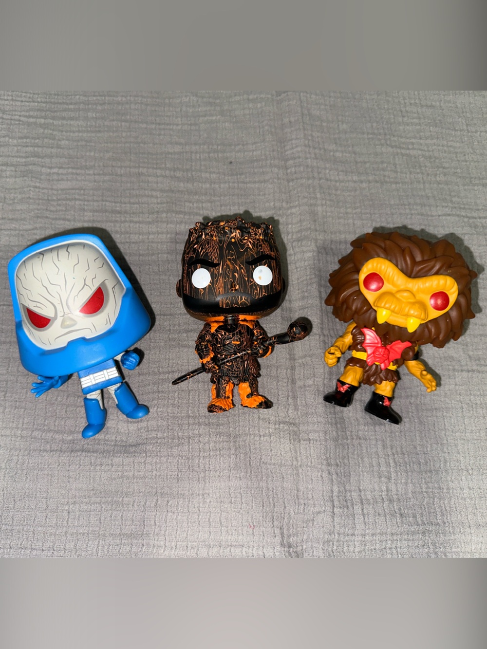 Funko Trio: Blue Hooded Figure, Black & Orange Wood Figure, Brown & Yellow Beast